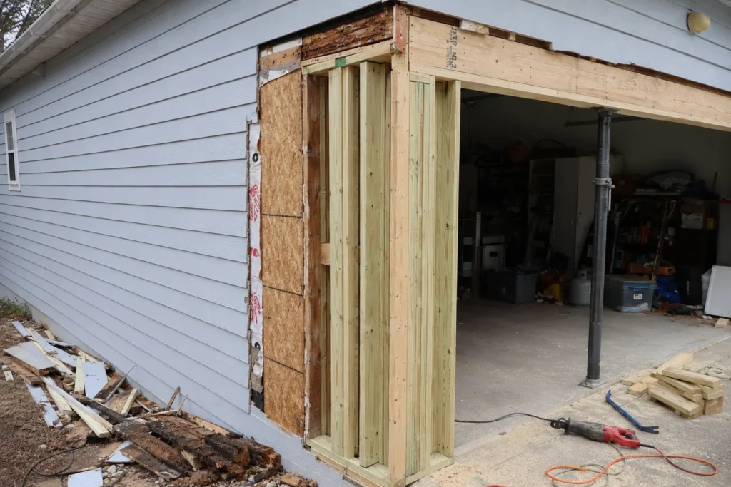 New structural framing and garage header support exposed during a residential repair.